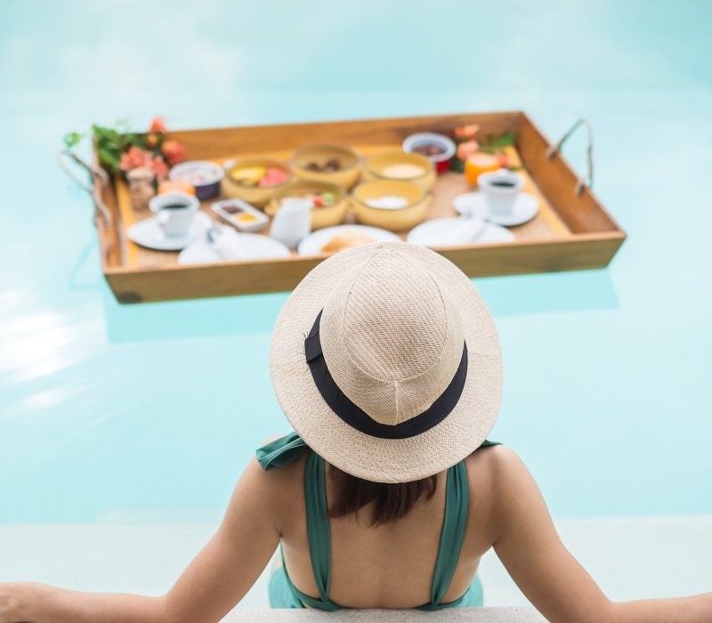 woman-having-floating-breakfast-in-luxury-pool-hotel-girl-with-hat-enjoy-in-tropical-resort.jpg